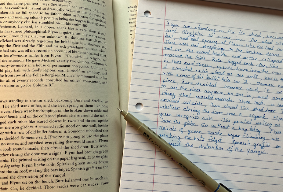 John LeCarre's "The Night Manager" open and a hand-written page with one of his paragraphs copied out.